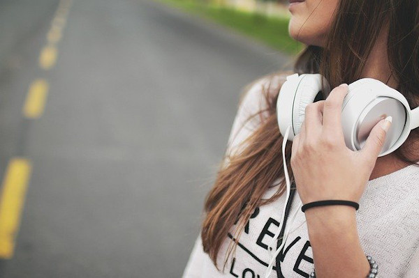 Girl on a road wearing headphones