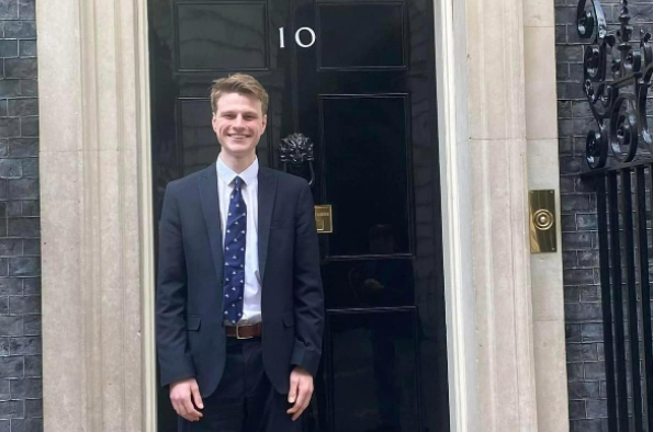 Student Daniel Bowman smiles at the camera in front of number 10
