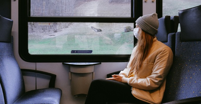 Woman wearing mask on train