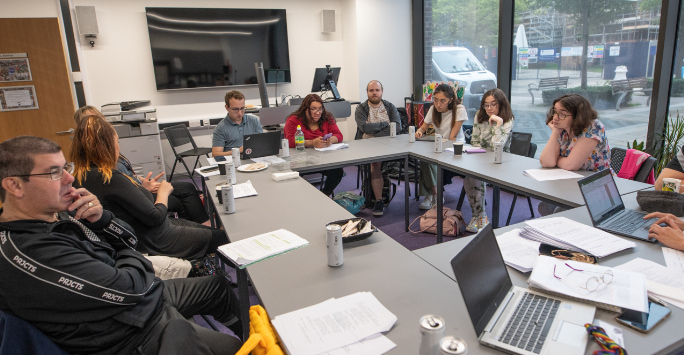 Members of the REACHE project discussing the project during a team meeting