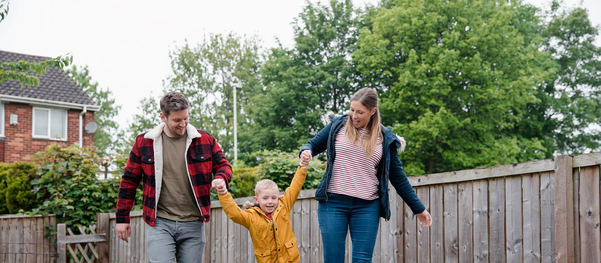 Mother and Father in garden with little boy