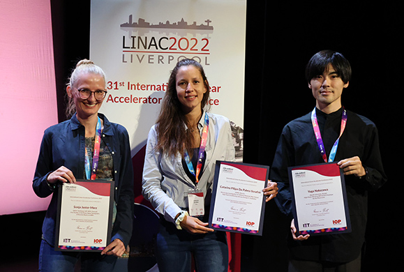 Three students holding a certificate