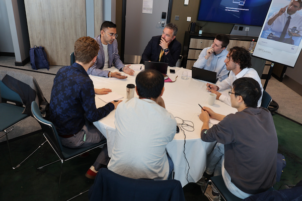People sitting on a round table during a discussion.