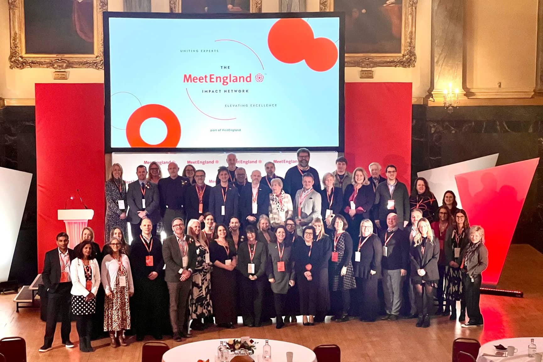 A large group of people posing for a picture on a stage.