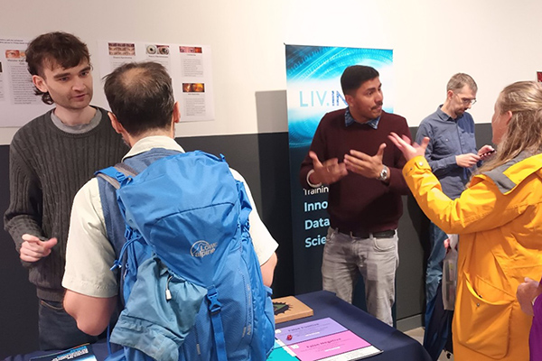 Students during an outreach event, explaining research to general public.