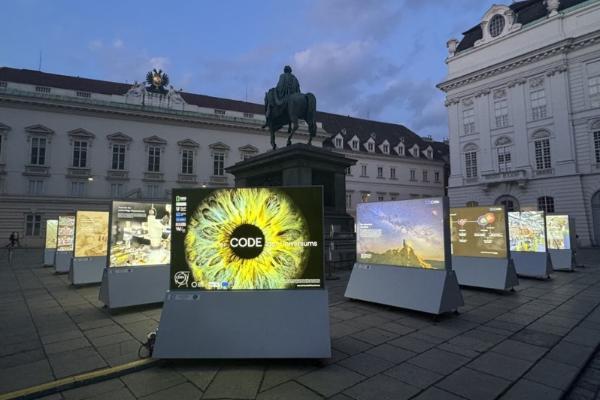 An exhibition with scientific pictures. Prominently in the middle an image of an eye.
