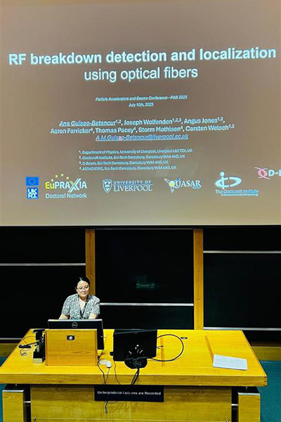 A student in behind a lectern, giving a talk.