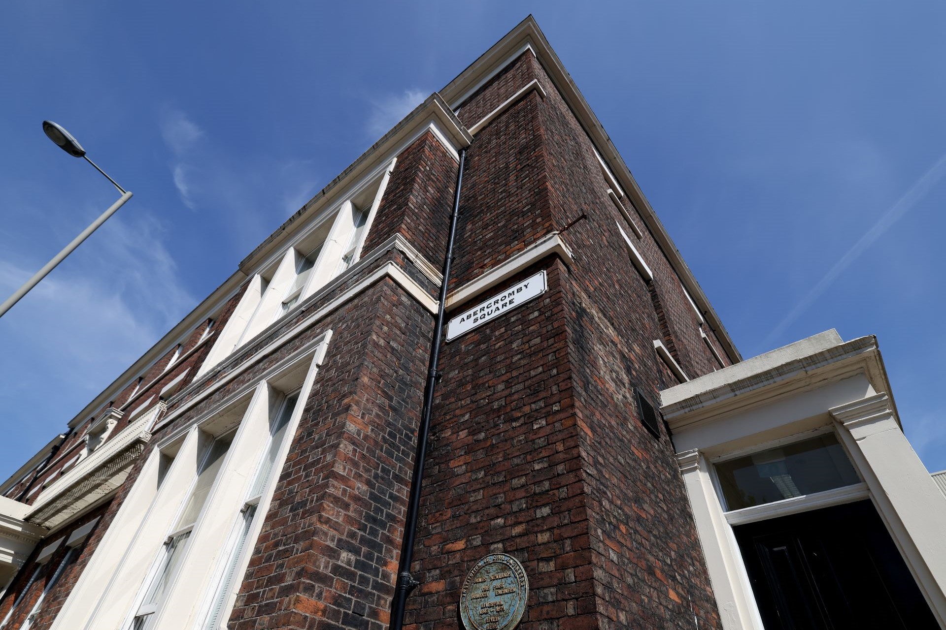 A building in Abercromby Square on campus, with the street sign in view.