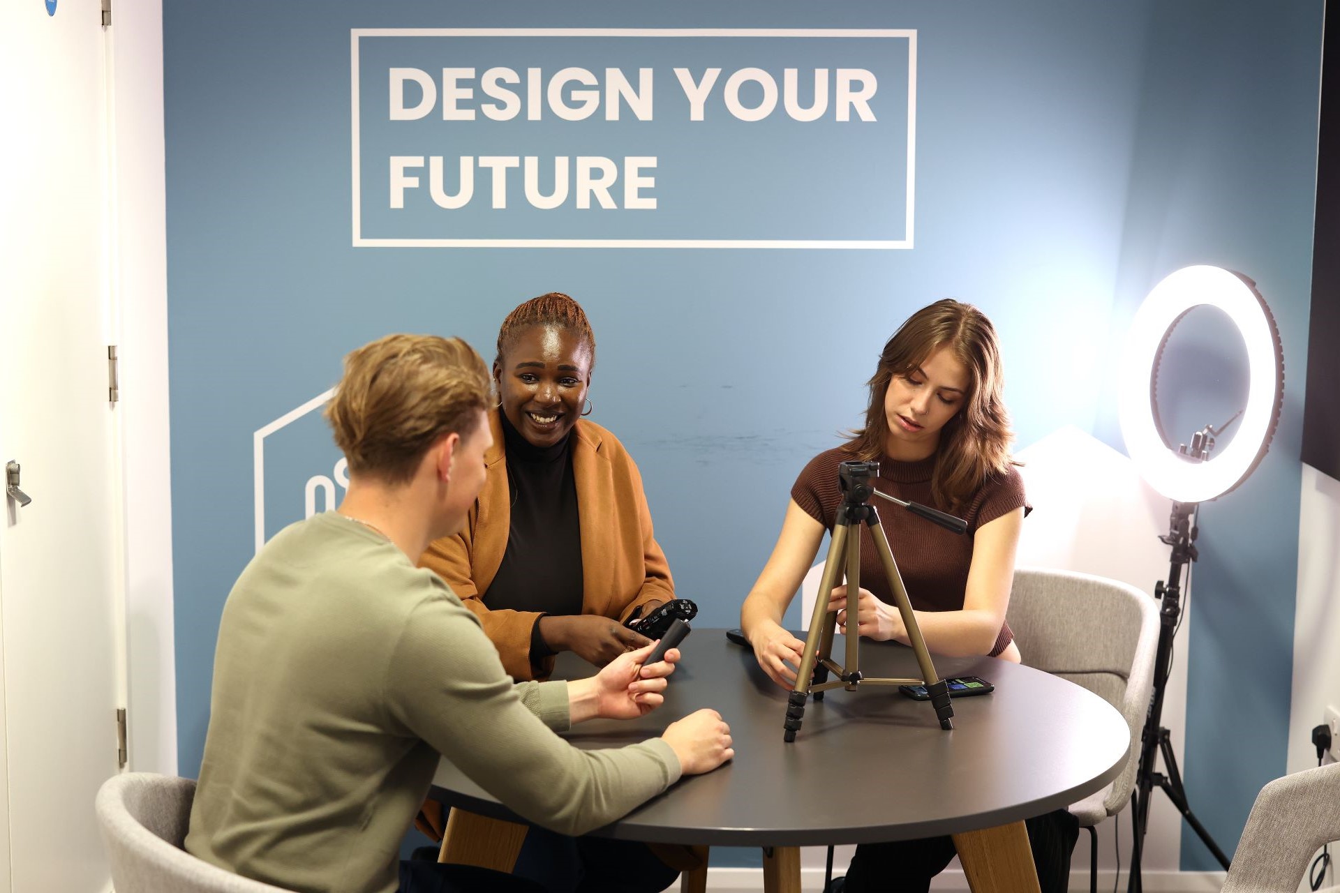 A group of young people using the podcast and media studio at the Sir Peter Rigby Centre.
