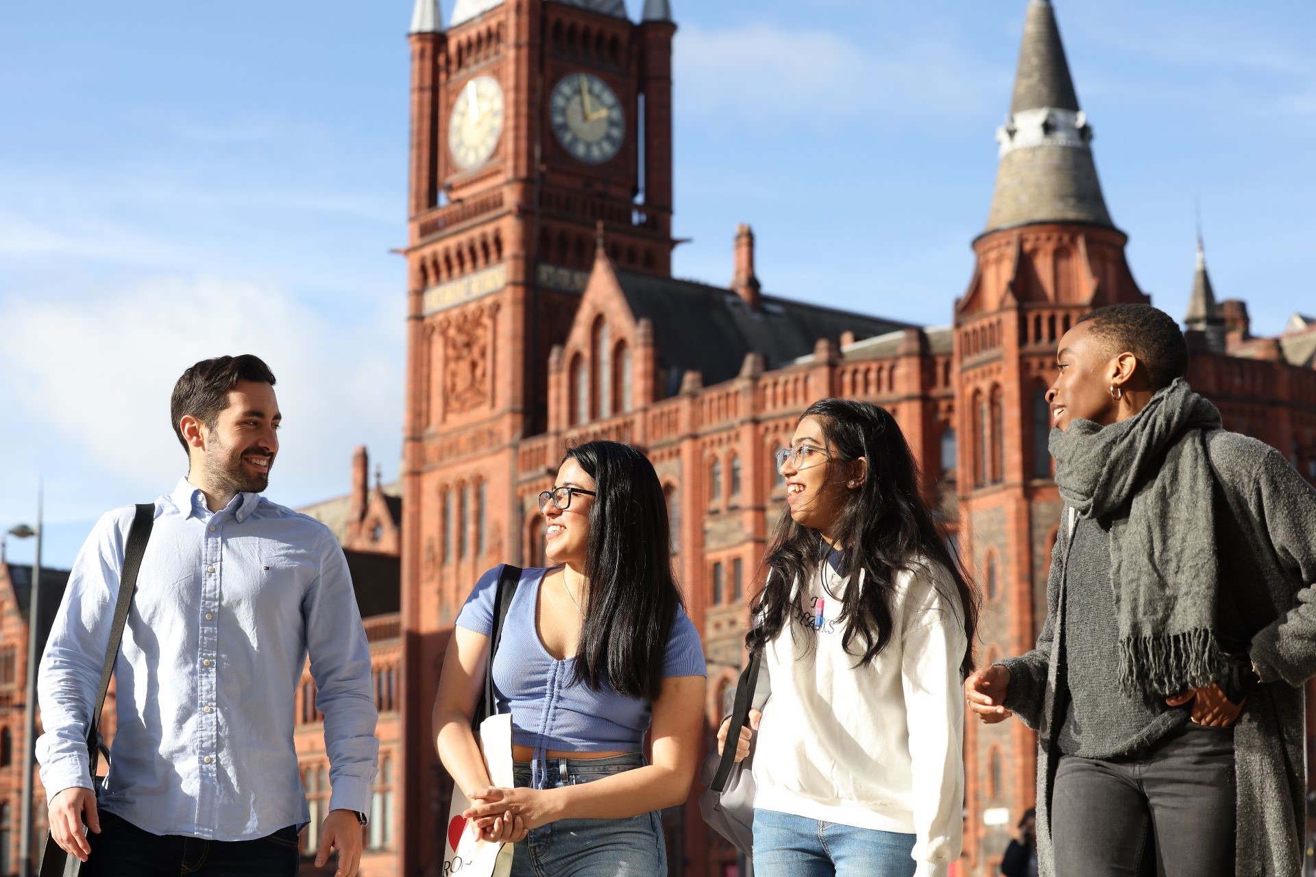 A group of students walking across University Square with the Victoria Gallery & Museum in the background.