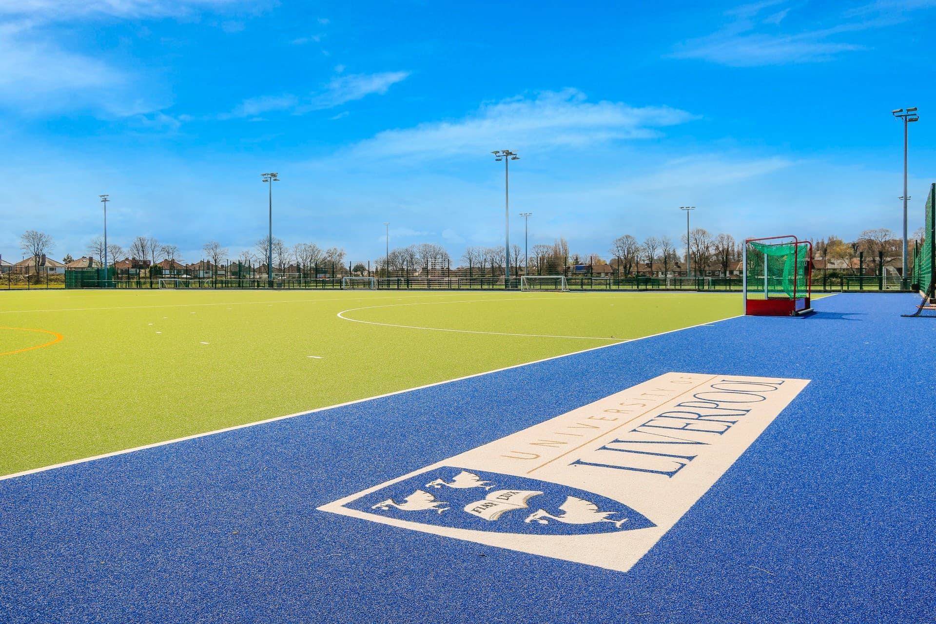 A picture of a hockey pitch at Wyncote Sports Ground with the University of Liverpool logo in the foreground.