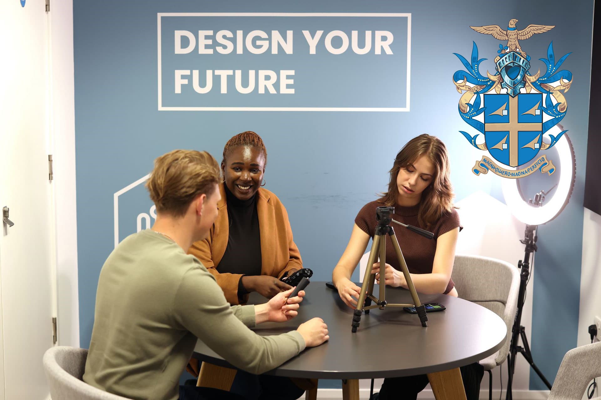 Students using the podcast studio Sir Peter Rigby logo