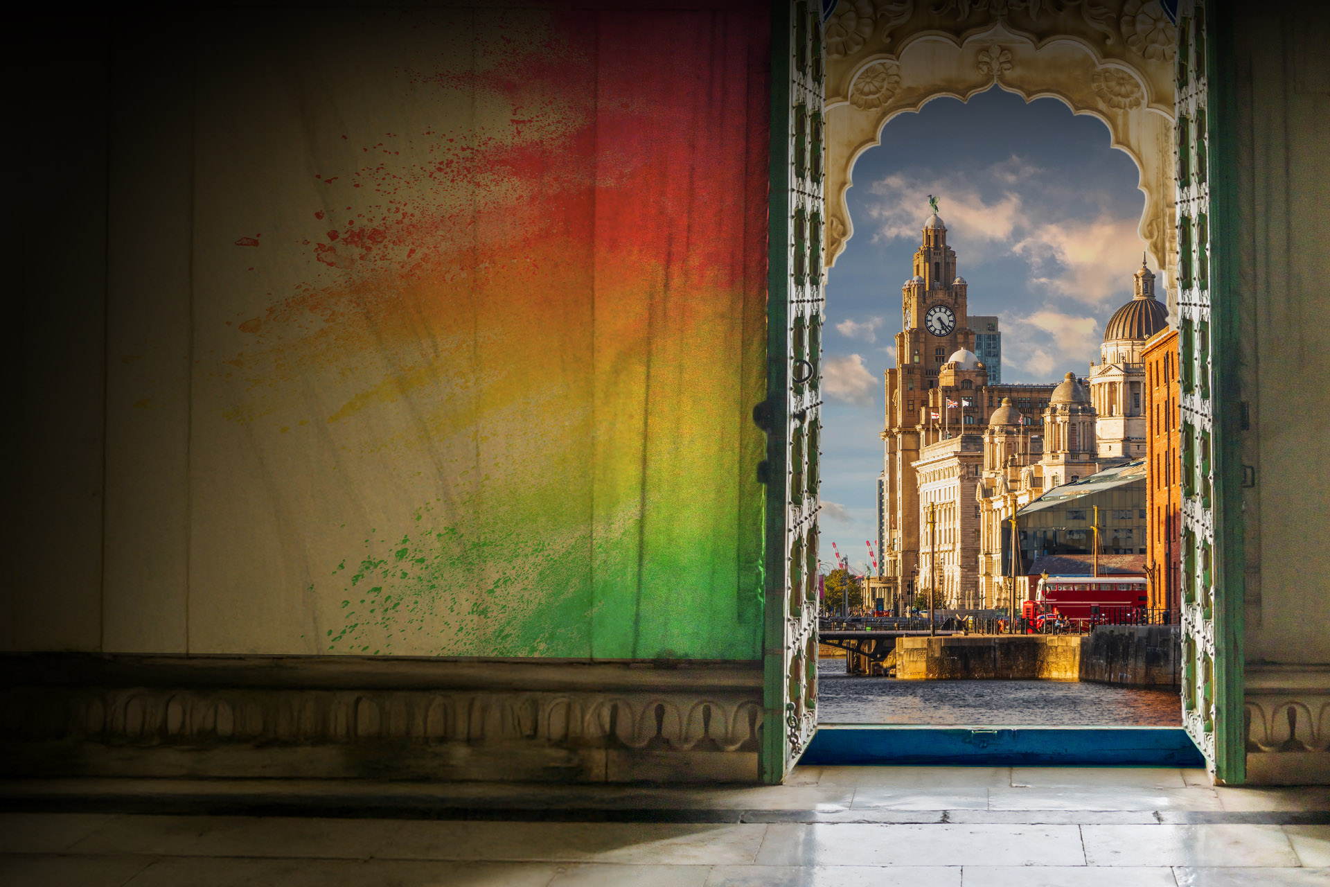 A wall with colourful paint and a door, through which you can see the city of Liverpool.