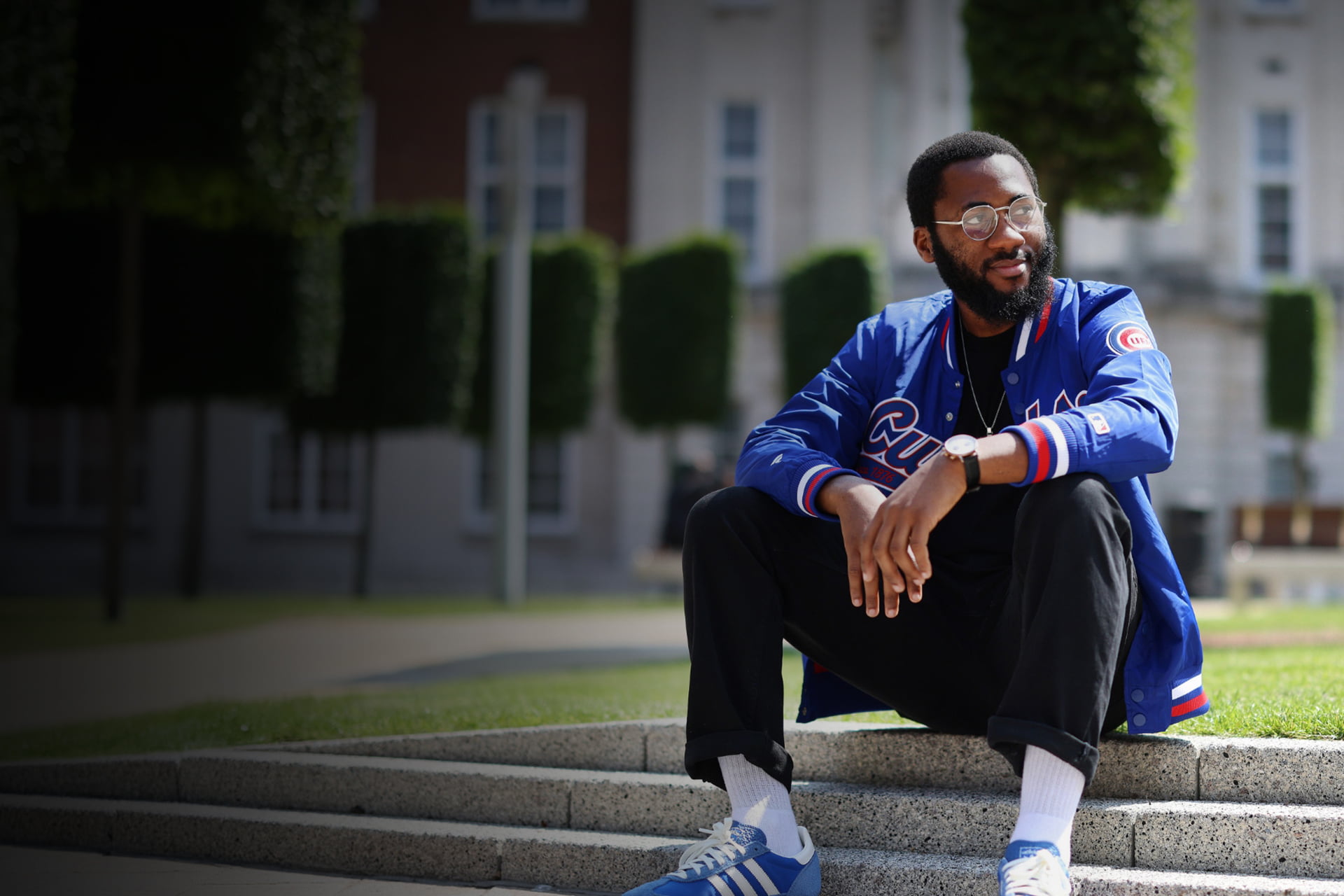 Student sitting on the steps in the University Quadrangle