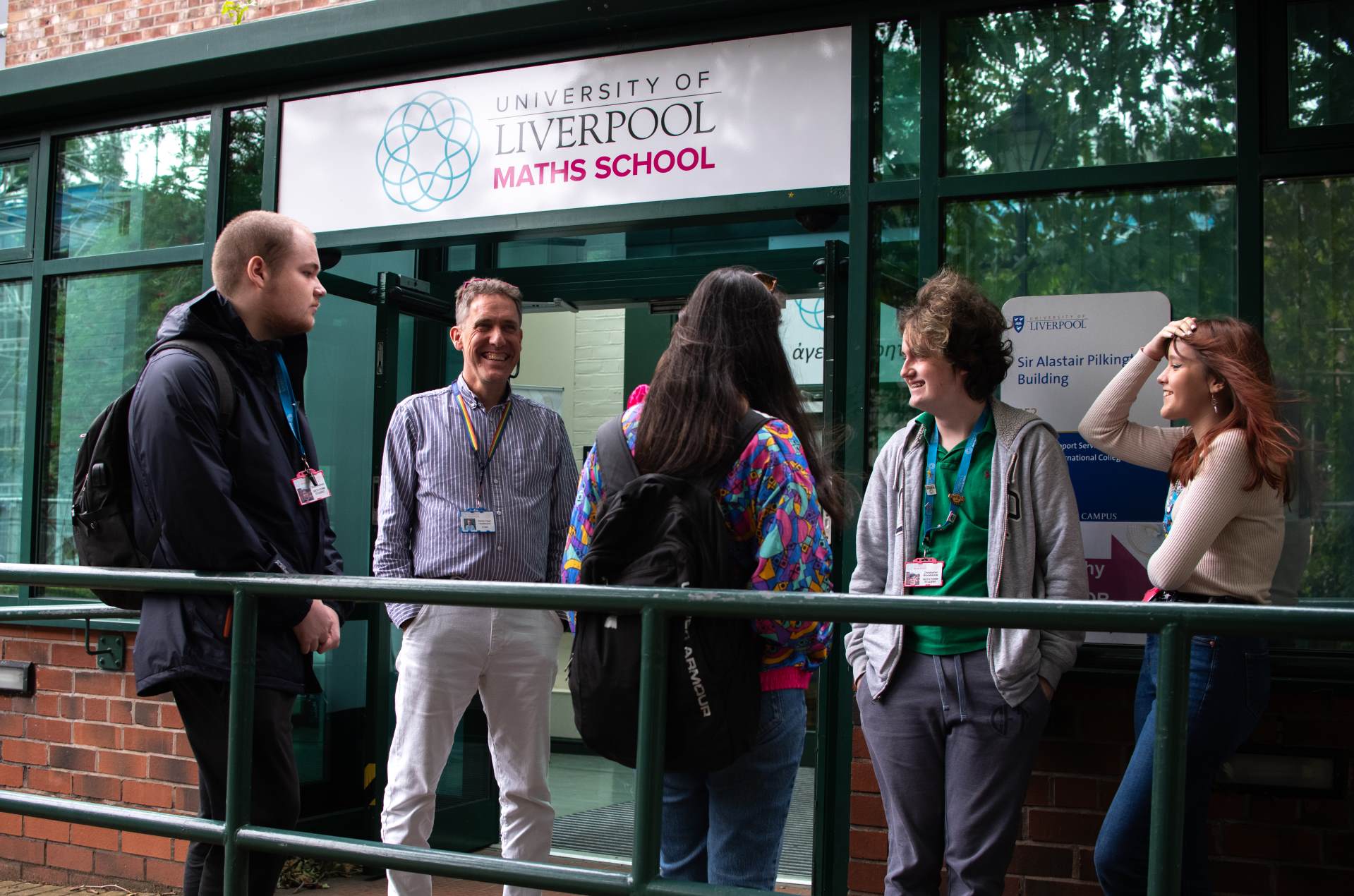 Group of students standing outside the Maths School building with the headteacher