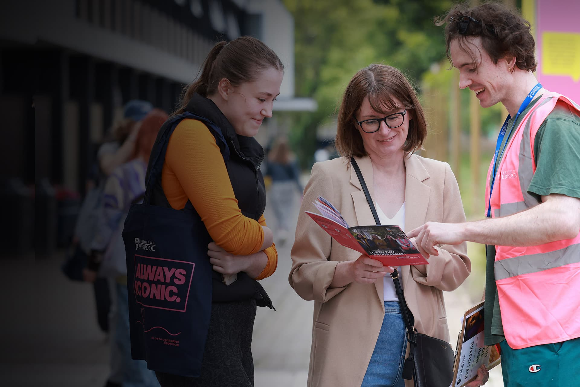 Daughter and Mum talking to a member of staff outside at an open day