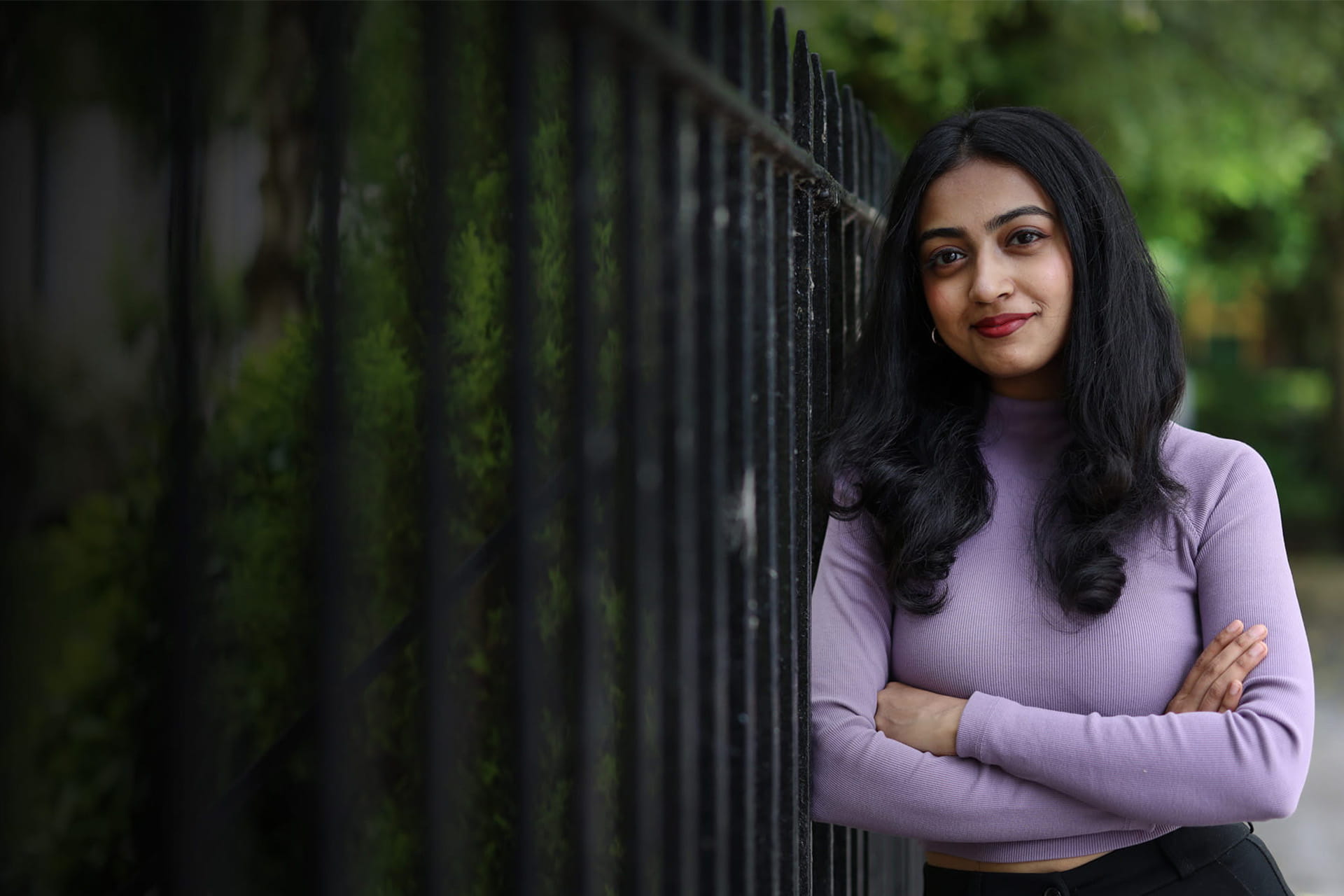 Student standing against the railings of Abercromby Square