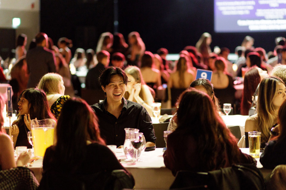 Students at an event talking at tables