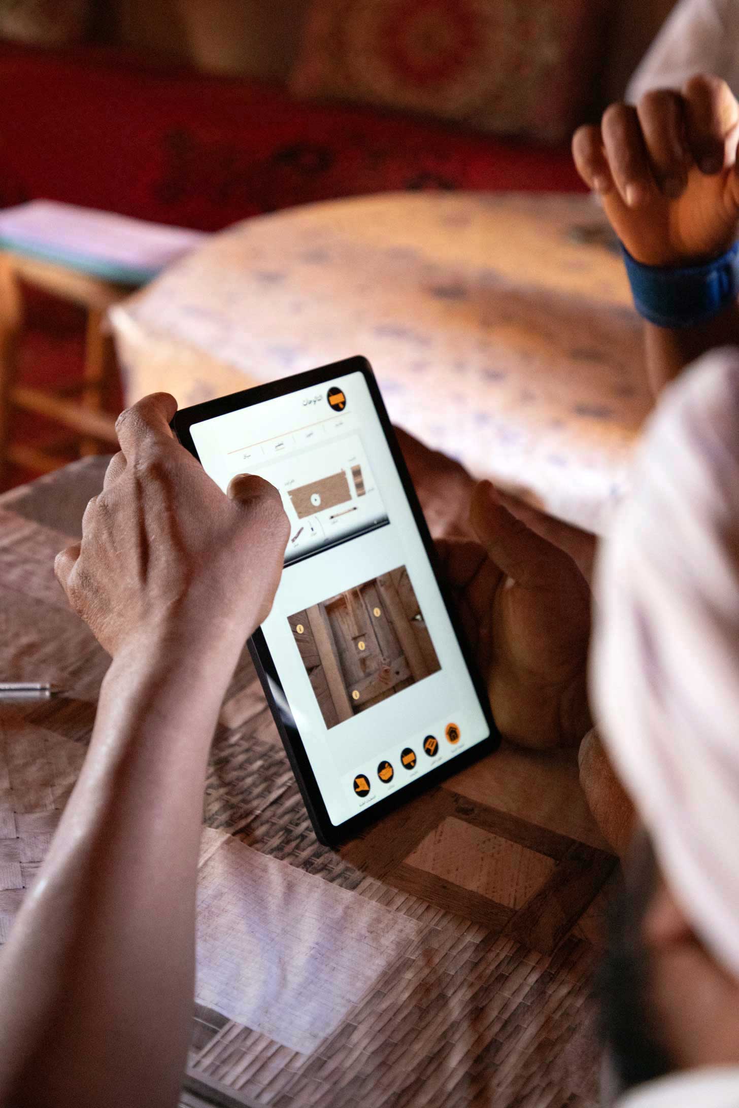 Craftsmen testing the digital construction manual Heres in M’Hamid Oasis, Morocco