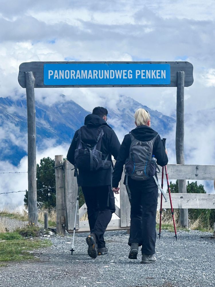A couple hiking through the beautiful Zillertal Alps, surrounded by sweeping mountain views and fresh alpine air.