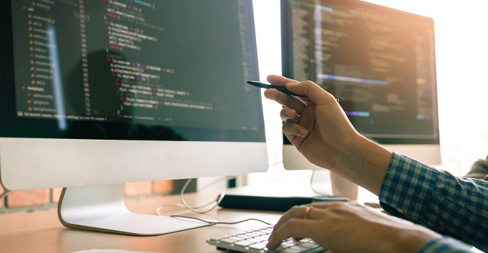 Person working on computer code at a computer