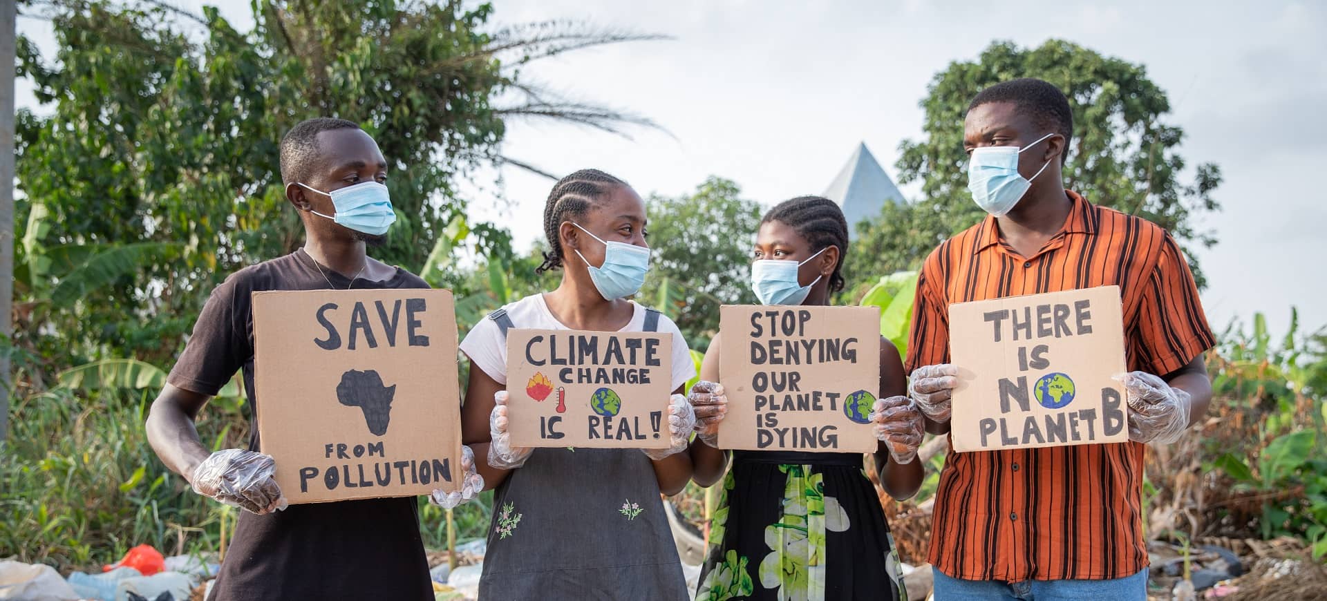 A group of people holding signs about climate change