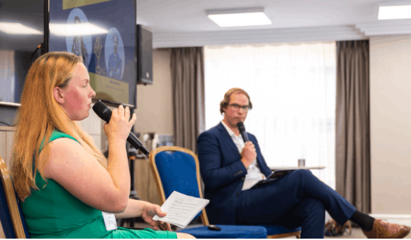 Two people presenting on stage