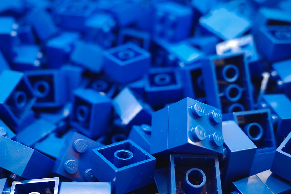 A close up shot of many blue lego bricks that are all of varying sizes.