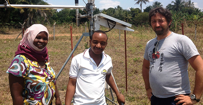 Cyril Caminade and colleagues standing in front of weather station