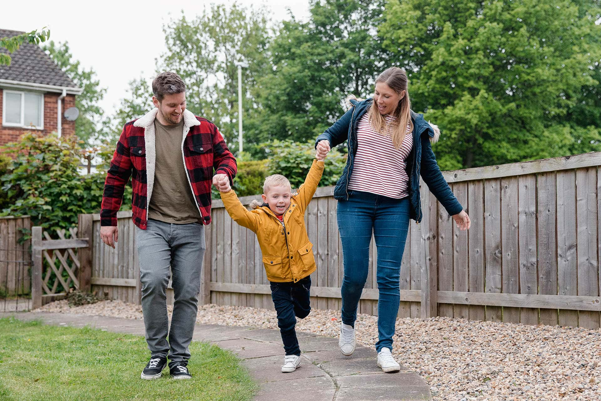 Mother and Father in garden with little boy