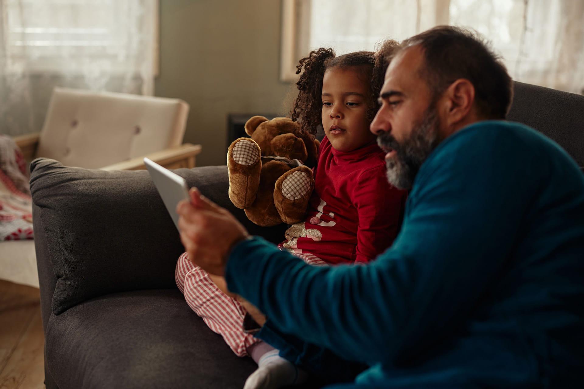 Father and daughter looking at tablet together