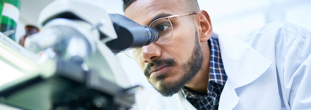 Scientist using a microscope