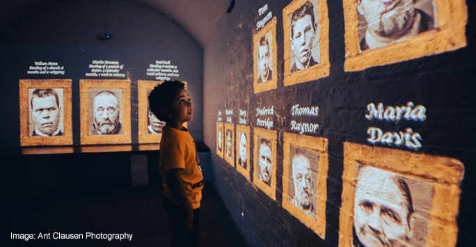 A young boy looking at projected images on a wall