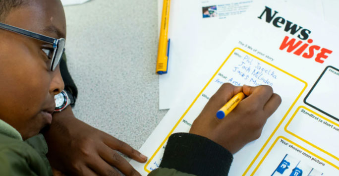 Young boy writing in a worksheet