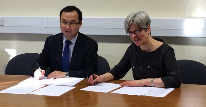 Two people signing agreement