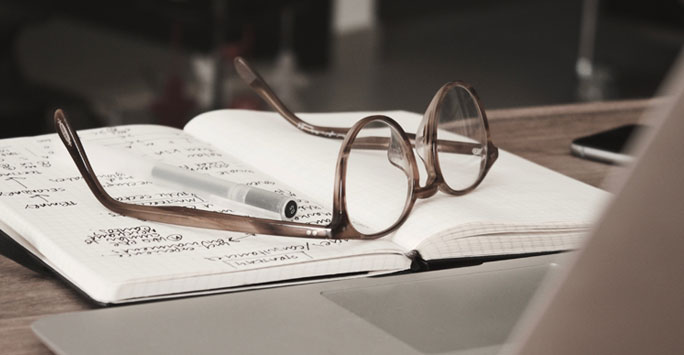 Reading glasses on a notebook