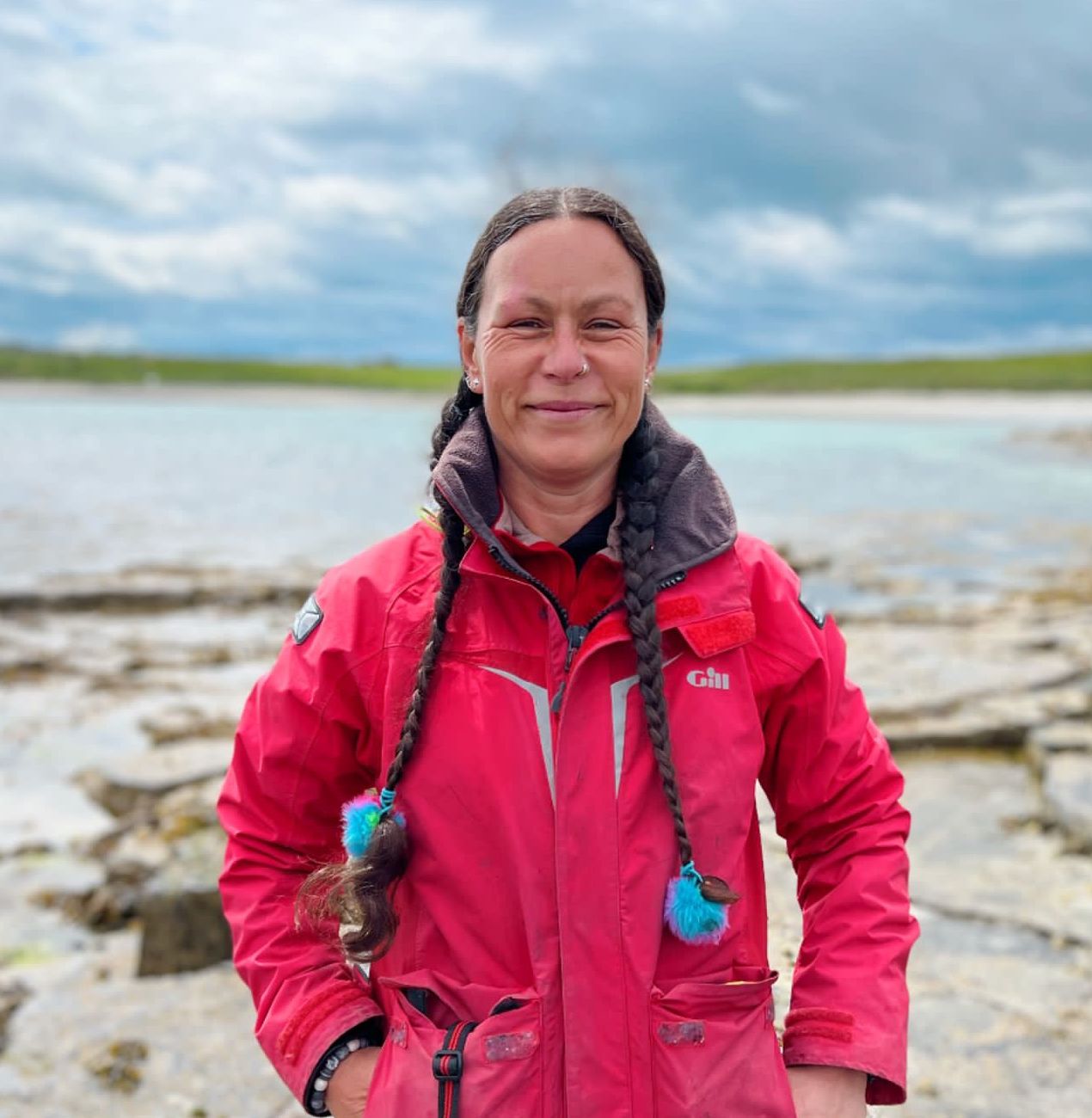 Person in front of water and rocks