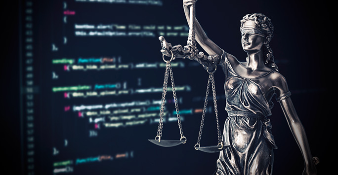 Lady Justice in front of computer screen