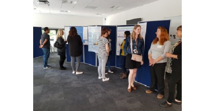 Researchers chatting at a poster session.