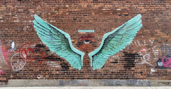 Wings painted on a brick wall
