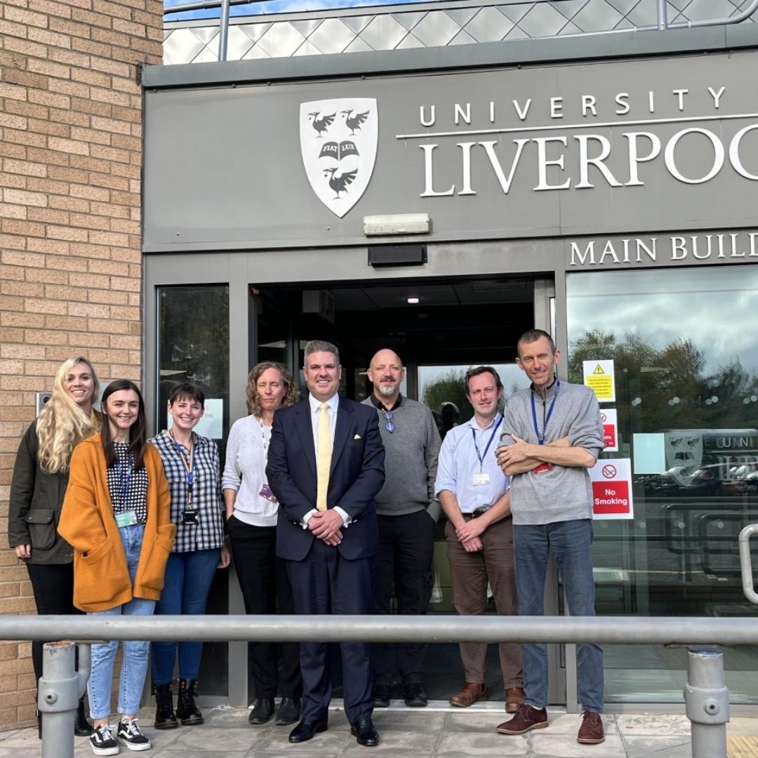 Group of colleagues photographed outside the Main Entrance at the Leahurst campus