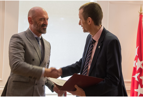 Image of two men in suits shaking hands