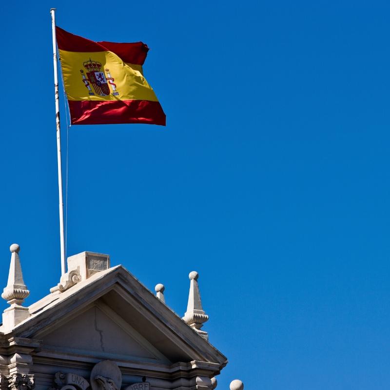 Spanish flag flying in a blue sky
