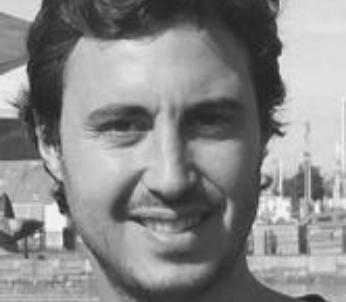 Greyscale image of male with short dark hair