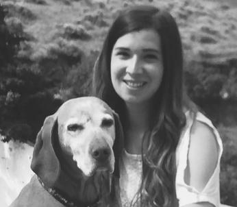 Female with long hair sat with Vizsla dog