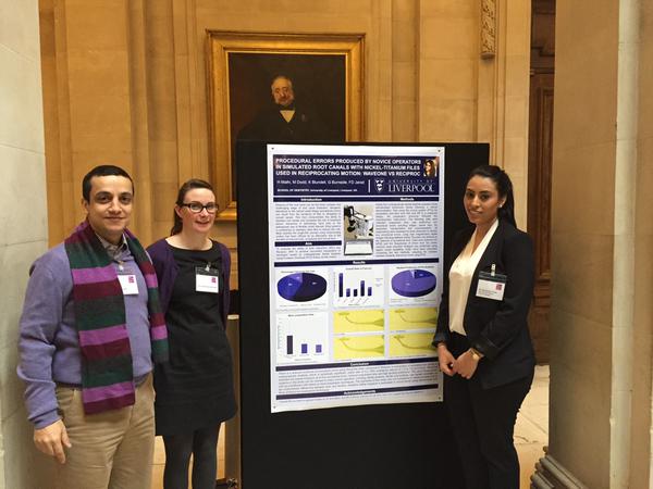 Dr Jarad and Miss Blundell stand to the left side of the student poster with student on right side of her elective poster