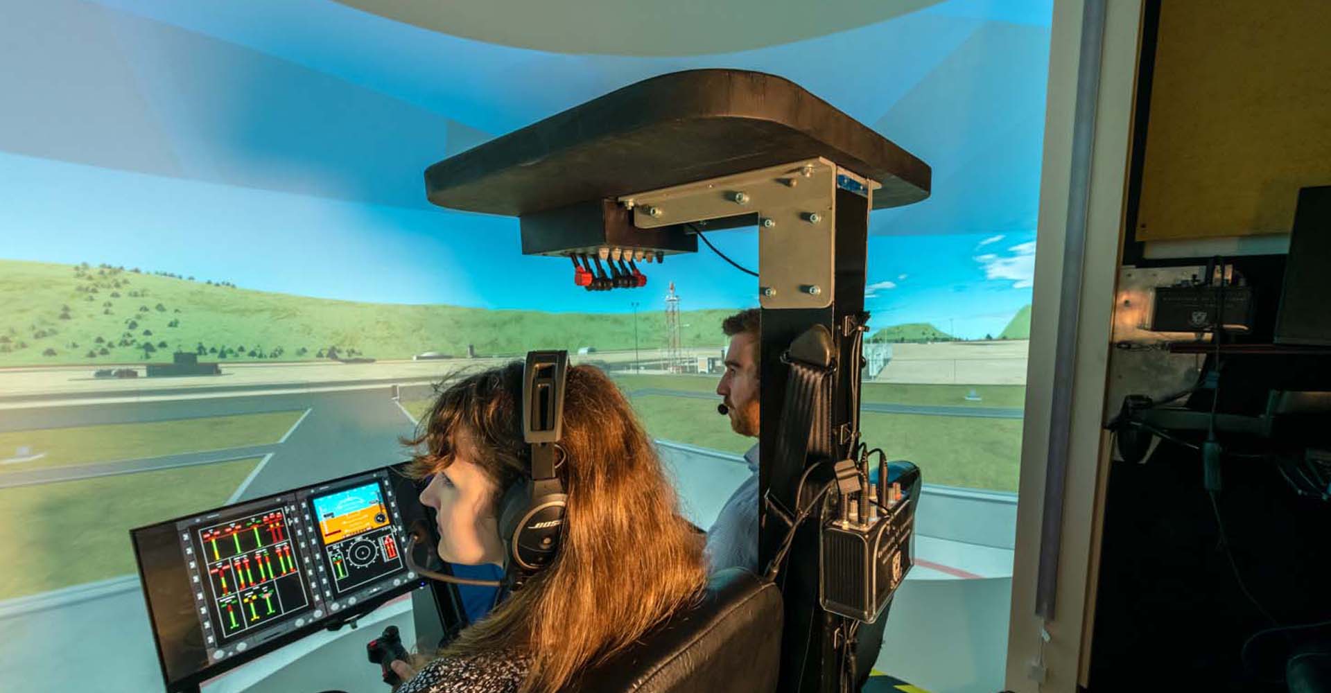 Aerospace engineers sat at controls in flight simulator