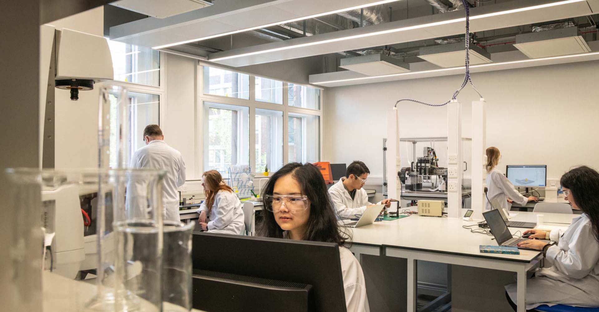 Engineer sat at computer in lab