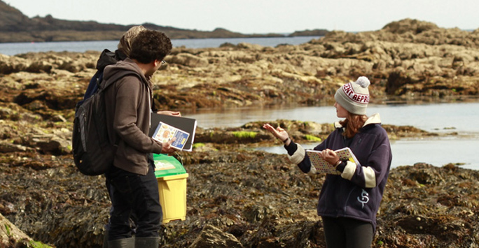 ecology students standing by water front