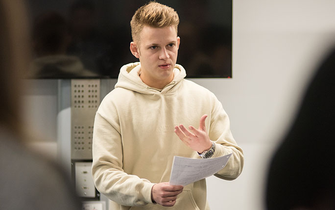 Student reading out work to class